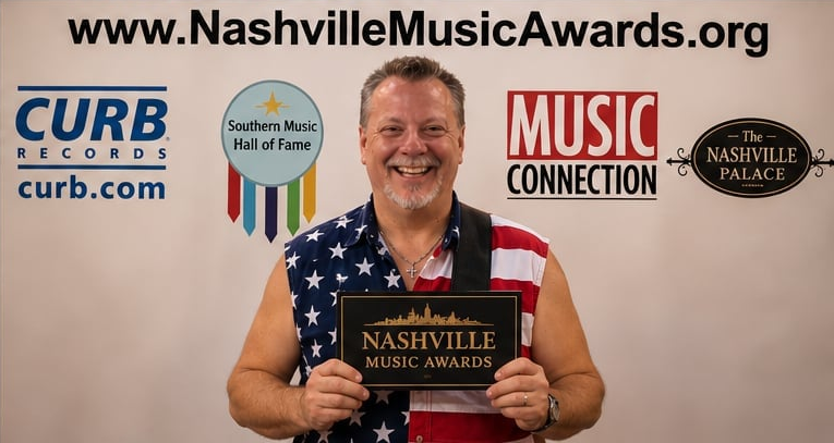 John DeRosa holding Nashville Music Awards plaque